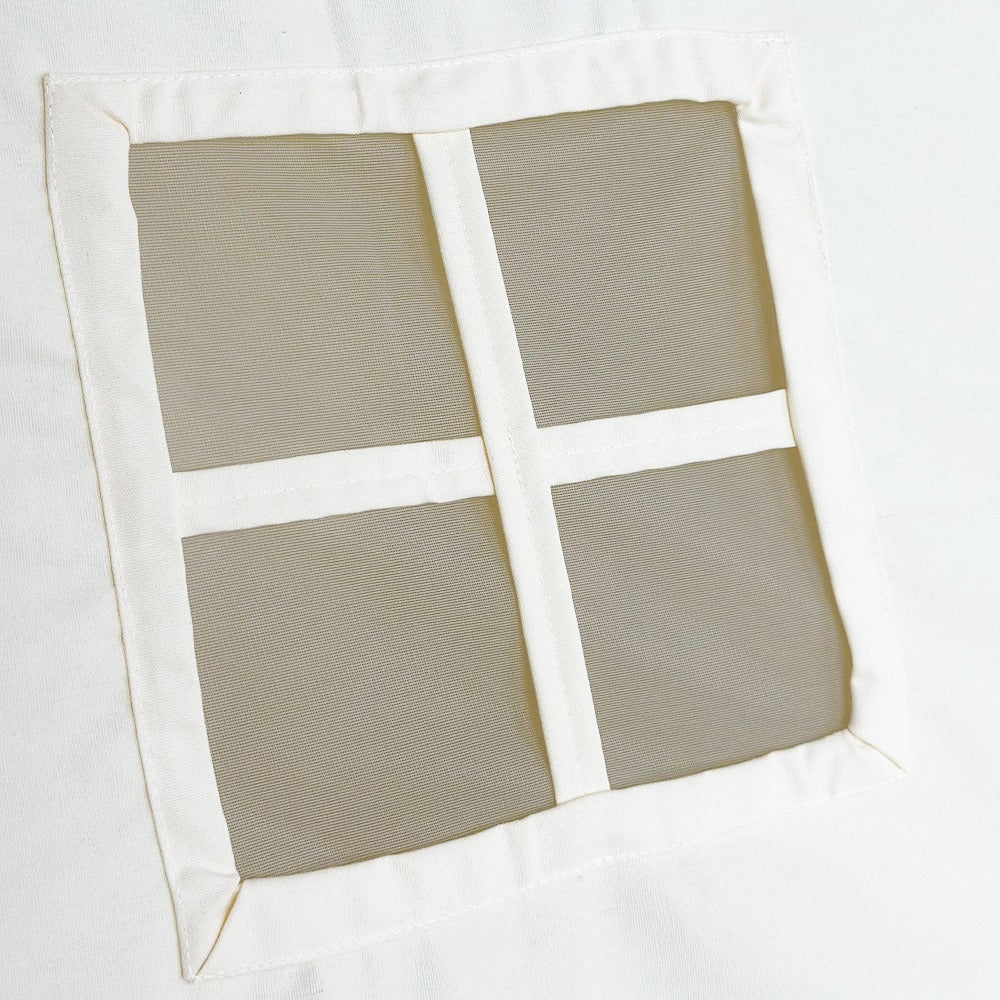 Close-up view of the little window on the side of the tepee tent. It has white lines that make it look like four small squares.