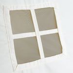 Close-up view of the little window on the side of the tepee tent. It has white lines that make it look like four small squares.