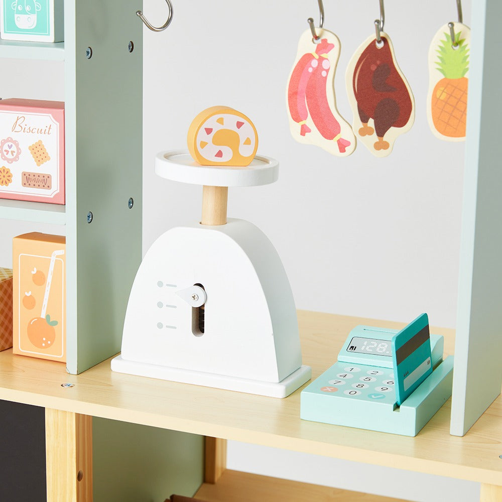 Front view of the Children's Supermarket with elements made with wood and suitable for children aged three and above. The shop toy promotes motor skills in children.